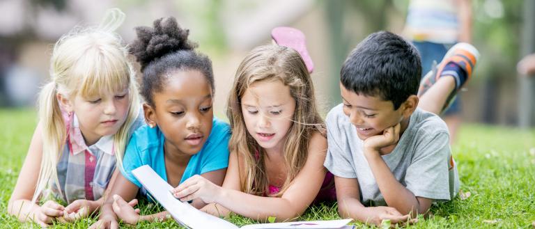 Kids reading in the park