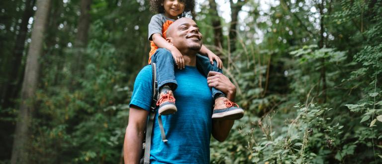 Father and son walking through a park