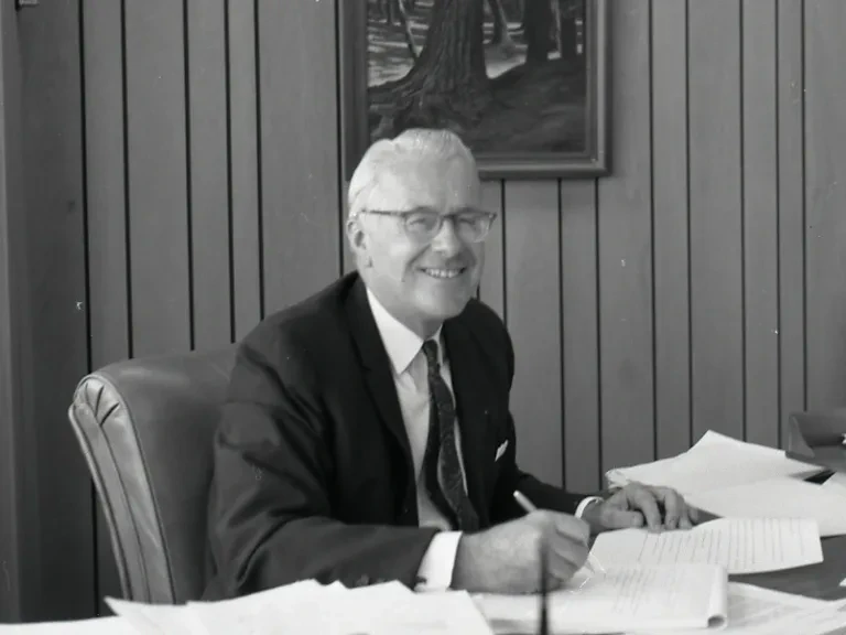 William Penn Mott, Jr at desk 