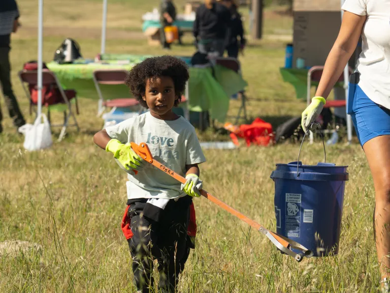 Young boy walking through field at California State Parks Foundation Earth Day event. 