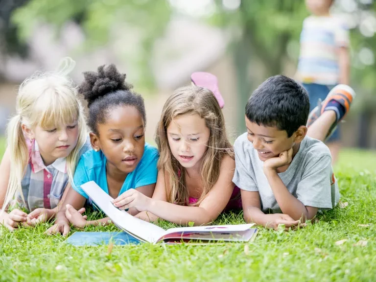 Kids reading in the park