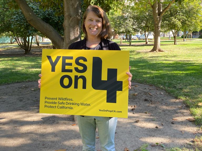 California State Parks Foundation Executive Director, Rachel Norton, holding a Yes on 4 sign in Sacramento