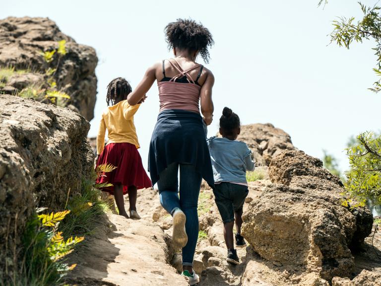 Woman hiking with two kids