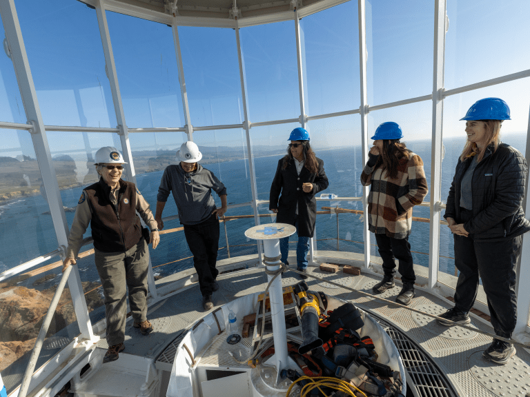 Visitors gather at the top of the lighthouse to learn about ongoing restoration work.