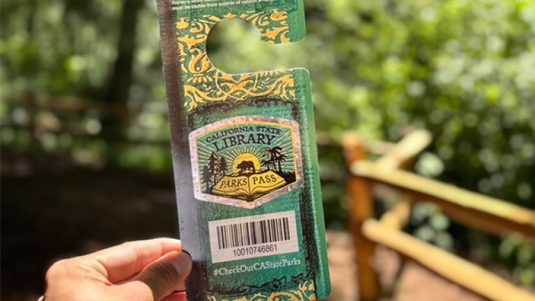 Person holding California Library Park Pass at Samuel P Taylor State Park