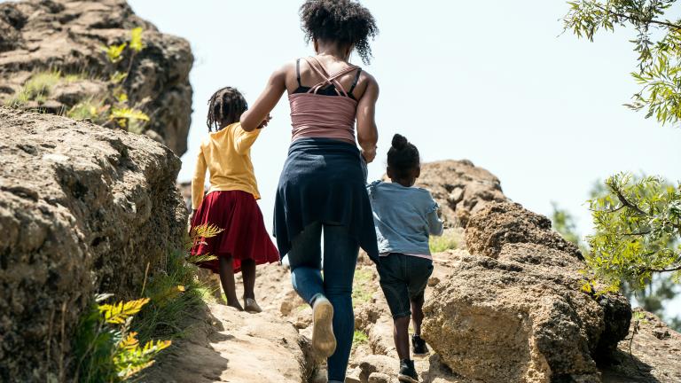 Woman hiking with two kids
