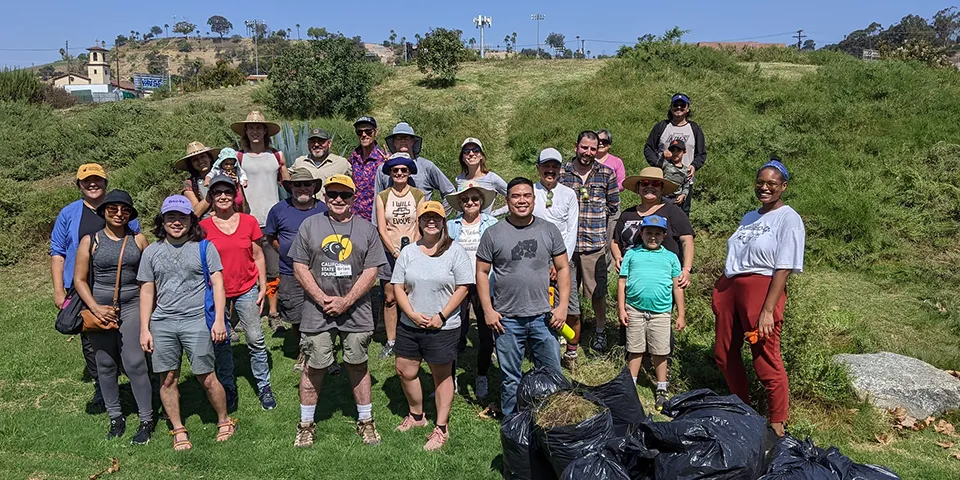 A group of volunteers with trash bags at Los Angeles State Historic Park