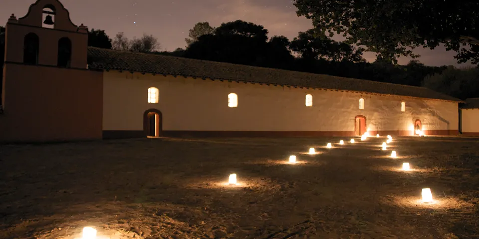 Candlelight pathway illuminated at La Purisima Mission State Historic Park