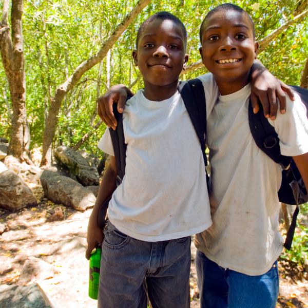 Two boys in wooded park
