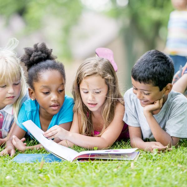 Kids reading in the park