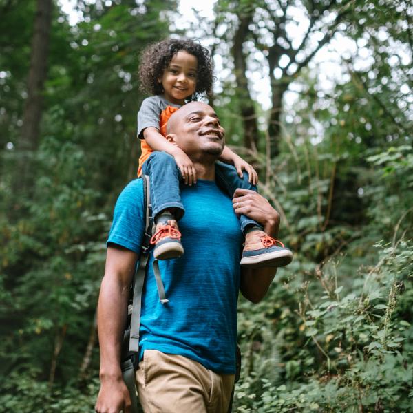 Father and son walking through a park