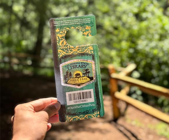 Person holding California Library Park Pass at Samuel P Taylor State Park